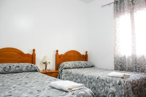 Katil atau katil-katil dalam bilik di Apartamentos El Galán II