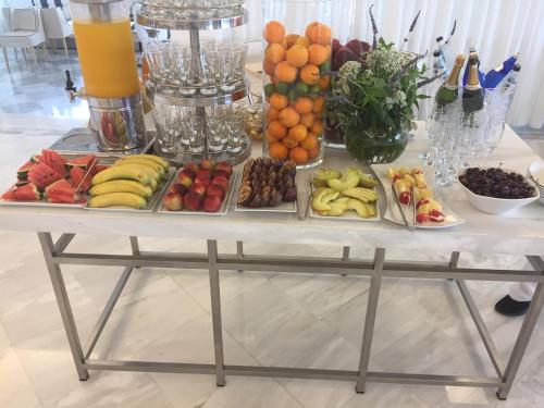 a table with many different types of fruit on it at Mykonos Grand Hotel & Resort in Agios Ioannis Mykonos