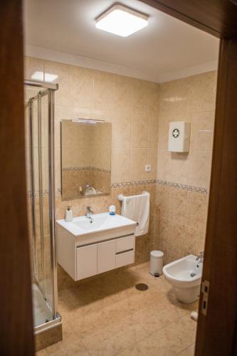 a bathroom with a sink and a toilet at PortoHouse in Porto
