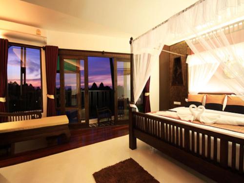 Postel nebo postele na pokoji v ubytování Dee Andaman Hotel
