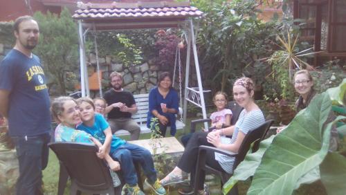 a group of people sitting in chairs in a garden at Oxygen Homestay-A Blissful Retreat in Dehradun
