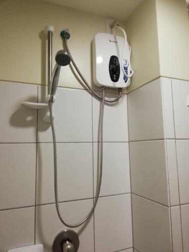 a shower in a bathroom with a shower head at Nica's Place Property Management Services at Horizons 101 Condominium in Cebu City
