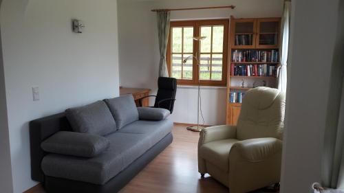 a living room with a couch and a chair at Ferienwohnung Winkl in Liesing