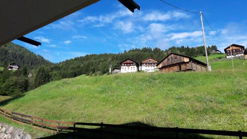 a group of houses on top of a grassy hill at Ferienwohnung Winkl in Liesing
