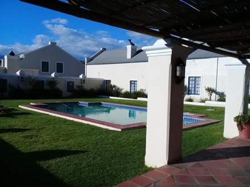 a house with a swimming pool in the yard at Morgansvlei Country Estate in Tulbagh