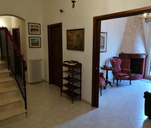a living room with a staircase and a fireplace at "Il Giardino Di Niu" in Palombaro
