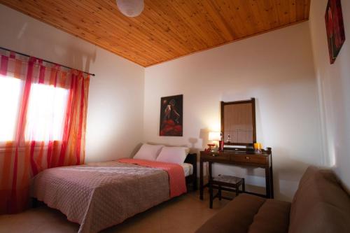 1 dormitorio con cama y mesa con espejo en Villa Melissa en Ayía Semní