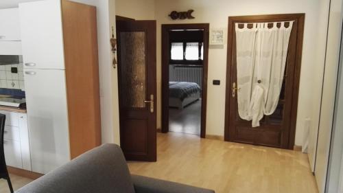 a living room with two doors and a couch at Appartamento Modena Park in Modena