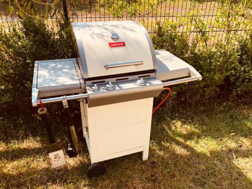 a barbecue grill sitting on the grass in the yard at Polo Villa & Suites in Podstrana