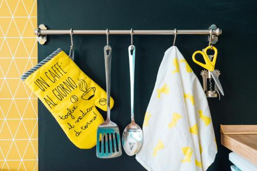 two kitchen utensils and a happy new year towel at Smile apARTment in Novi Sad