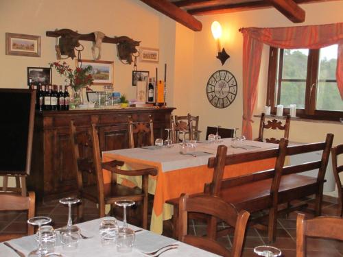 a dining room with a table and chairs with wine glasses at Agriturismo Il Felciaione in Massa Marittima
