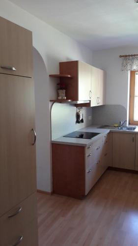 a kitchen with white cabinets and a sink in it at Ferienwohnung Winkl in Liesing