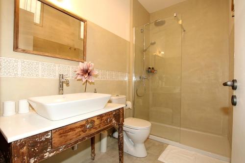 a bathroom with a sink and a shower and a toilet at 1861 Liston Boutique flat in Corfu