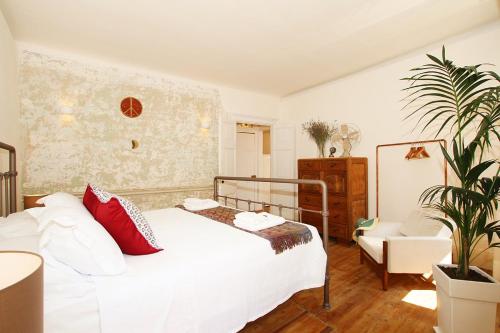 Schlafzimmer mit einem weißen Bett und roten Kissen in der Unterkunft 1861 Liston Boutique flat in Korfu-Stadt