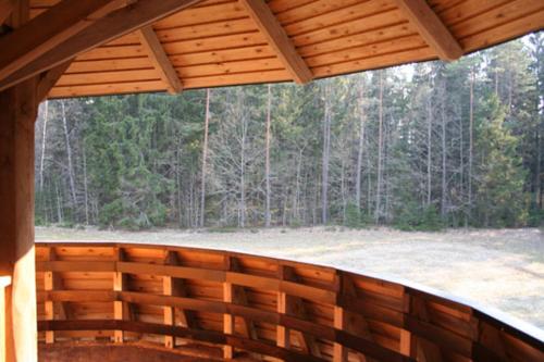 a screened in porch with a view of a forest at Turaidas zieds in Turaida