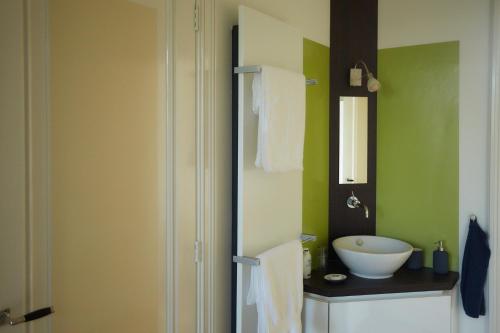 a bathroom with a white sink and a mirror at B&B Muntzicht in Utrecht