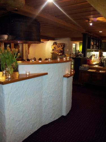 a bar in a restaurant with a counter at Hotel Restaurant Kulm in Triesenberg