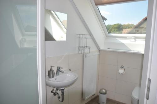 a bathroom with a sink and a window at Kiefer-Apartments in Rust