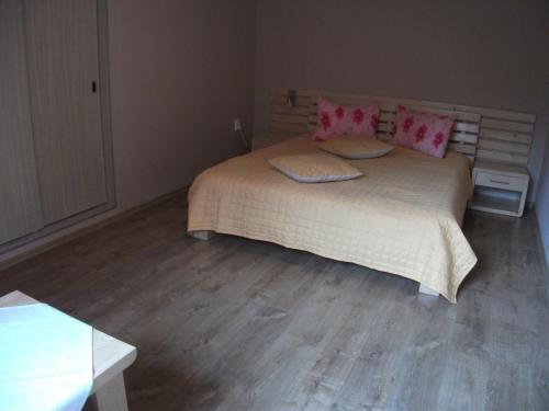 a bedroom with a large bed with pink pillows at Vila Sport Borsec in Borsec