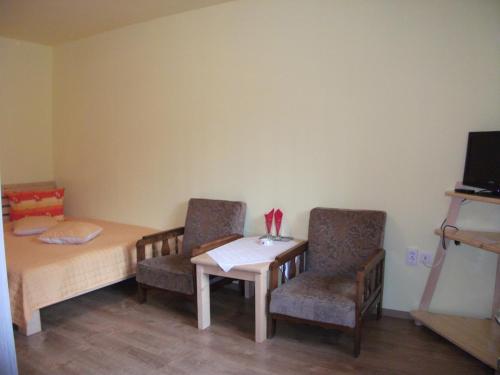 a dining room with a table and two chairs at Vila Sport Borsec in Borsec