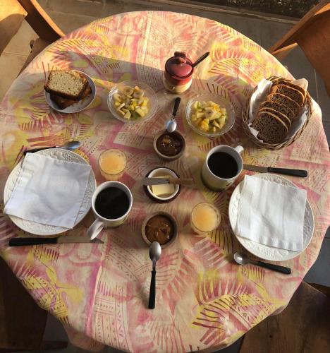 a table with plates and bowls of food on it at La Casa de Wanda in Villa de Las Rosas