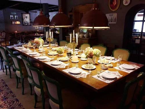 a long wooden table in a room with chairs at Hotel City Bell in La Plata