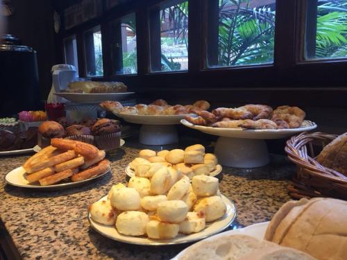 a table topped with plates of pastries and pastries at Hotel City Bell in La Plata