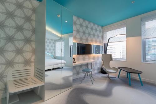 a bedroom with a bed and a desk and a table at Park Inn by Radisson Amsterdam City West in Amsterdam