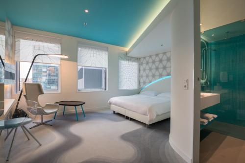 a bedroom with a bed and a desk and a chair at Park Inn by Radisson Amsterdam City West in Amsterdam