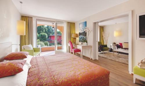 a hotel room with a bed and a living room at Giardino Ascona in Ascona