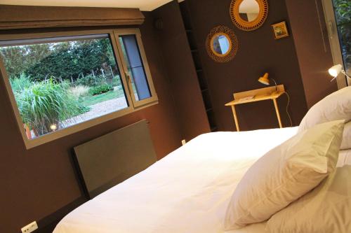 a bedroom with a large bed and a window at Archibien in Bois-de-Villers