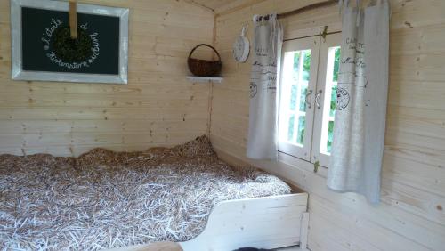 HildersにあるSchäferwagen "Hirtenstern"の窓付きの木造キャビン内のベッドルーム1室
