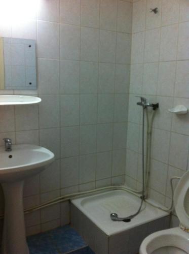 a bathroom with a tub and a sink and a toilet at Vila Sport Borsec in Borsec