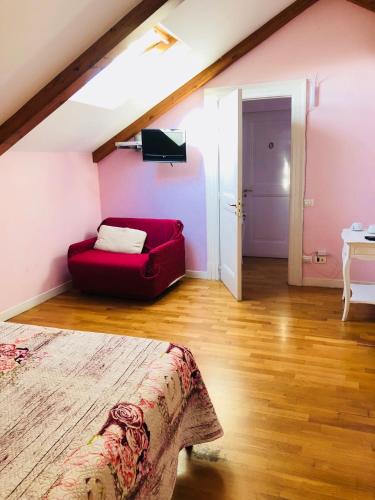 a living room with a red couch in a attic at The Secret Garden Relais in Piano di Sorrento