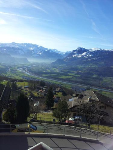 a view of a valley with snow covered mountains at Hotel Restaurant Kulm in Triesenberg