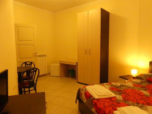 a bedroom with a bed and a table and a desk at BEB 2000 in Sassari