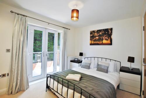 a bedroom with a bed and a large window at Spacious 2-Bedroom Apartment with Parking in Windsor in Windsor