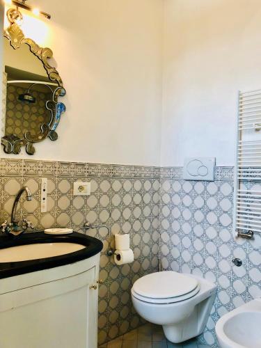 a bathroom with a toilet and a sink at The Secret Garden Relais in Piano di Sorrento