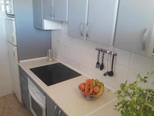 a kitchen with a bowl of fruit on a counter at Burrero Seasight in Ingenio