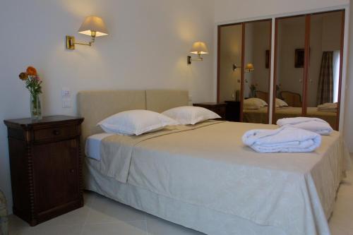 a bedroom with a bed with towels on it at Villa d'Estelle in Cannes