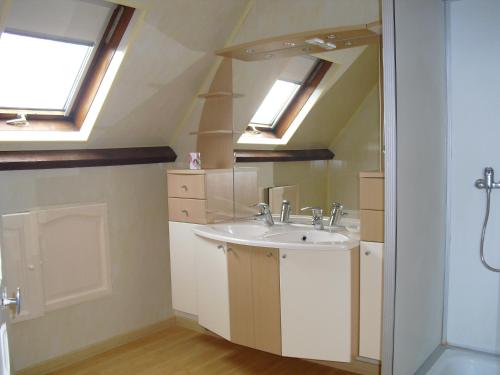 a bathroom with a sink and two skylights at Vacances à Réthoville in Réthôville