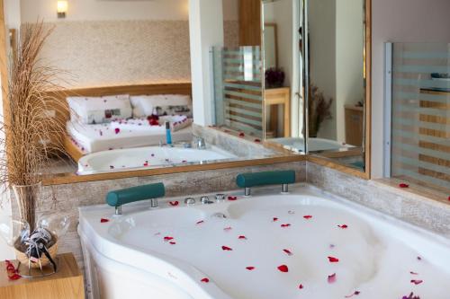 a bath tub with red hearts on it in a bathroom at Nur Hotel in Kas