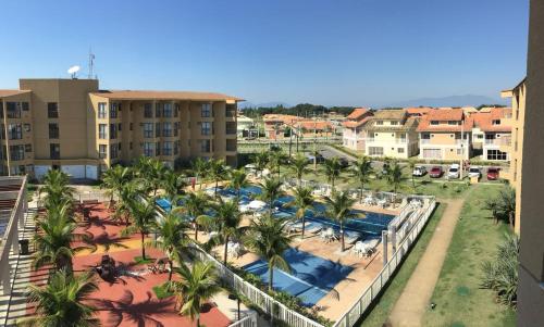 an aerial view of a resort with palm trees and pools at Tranquilidade e diversão in Mangaratiba