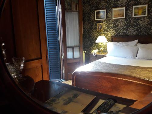 a bedroom with a bed and a remote control at Hotel City Bell in La Plata