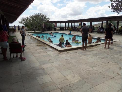 a group of people in a swimming pool at Flat Fazenda Cond Monte Castelo-Ao lado da Piscina in Gravatá