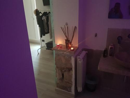 a room with a stone pillar with a candle on it at Il Daviduccio Suite in Siracusa