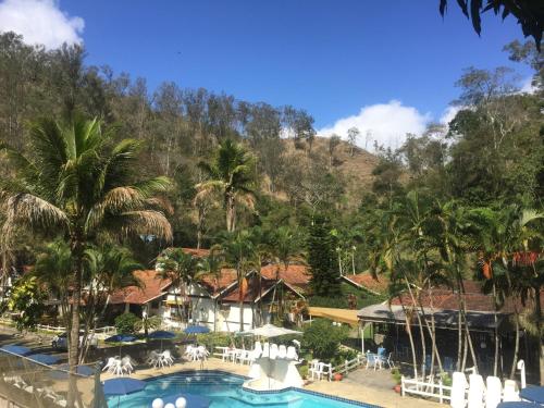 a view of a resort with a pool and palm trees at Hotel Colonial in Piraí