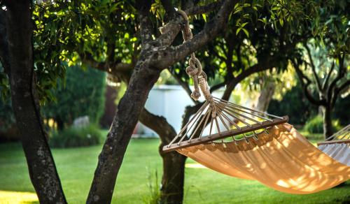 a hammock hanging from a tree in a park at Dimora La Grazia in Castelvetrano Selinunte