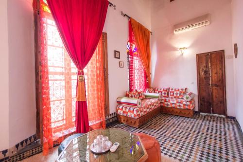 a living room with a couch and a table at Riad Dar Skalli & SPA in Fès