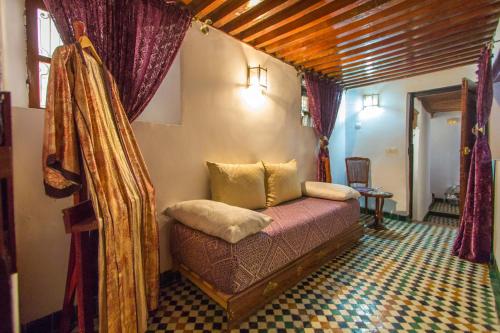 a bedroom with a bed in a room at Riad Dar Skalli & SPA in Fès